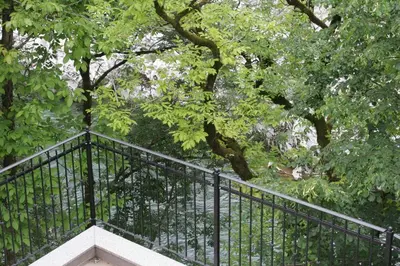 a wrought iron staircase in a park with trees at Apartments Jez in Slappe dʼIdria
