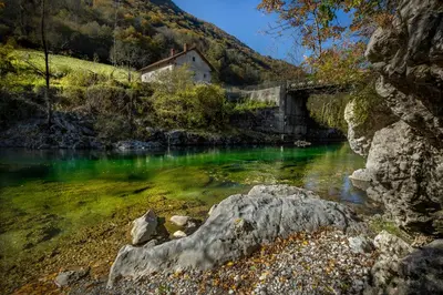 a bridge over a river with a house on it at Apartments Jez in Slappe dʼIdria
