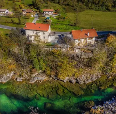an aerial view of a house on a hill next to a river at Apartments Jez in Slappe dʼIdria