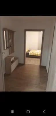 a room with a bedroom with a bed and a mirror at turistična kmetija pr mark in Trebče