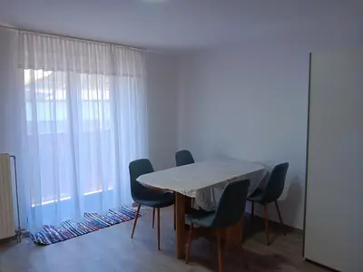a dining room with a table and chairs and a window at turistična kmetija pr mark in Trebče