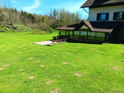 a pavilion with a picnic table in a yard at turistična kmetija pr mark in Trebče