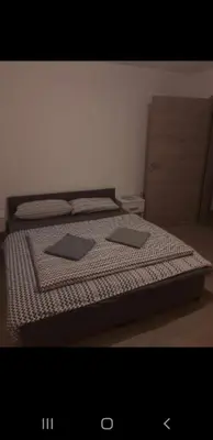 a bedroom with a bed with two monitors on it at turistična kmetija pr mark in Trebče