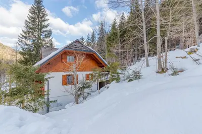 a cabin in the snow in the woods at Apartma Gaja in Kranjska Gora