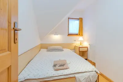 a small bedroom with a bed and a window at Apartma Gaja in Kranjska Gora