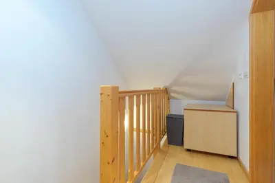 a room with a wooden staircase and a box at Apartma Gaja in Kranjska Gora