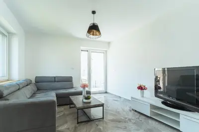 a living room with a couch and a flat screen tv at Julian Manor apartments in Bovec