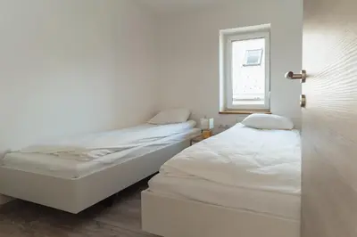 two beds in a small room with a window at Julian Manor apartments in Bovec