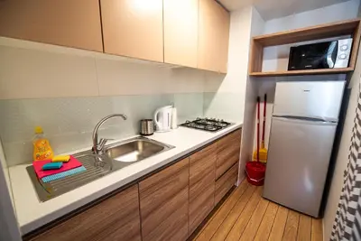 a small kitchen with a sink and a refrigerator at Mediteran Homes with Terme Čatež Tickets in Čatež ob Savi