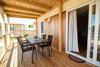 a wooden porch with a table and chairs on a deck at Mediteran Homes with Terme Čatež Tickets in Čatež ob Savi