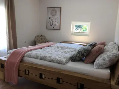 a bedroom with a bed with pillows on it at Hillside Bio Resort Apartment with Mountain View in Prebold