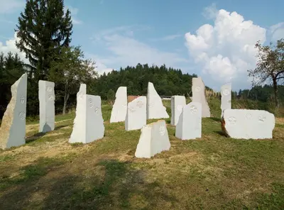a group of white monuments sitting in a field at Hillside Bio Resort Apartment with Mountain View in Prebold