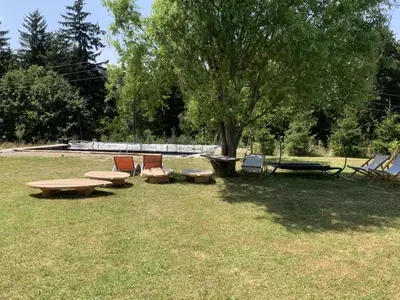 a group of picnic tables and chairs in a park at Hillside Bio Resort Apartment with Mountain View in Prebold