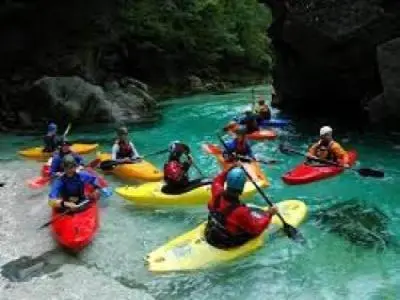 a group of people in kayaks on a river at Hillside Bio Resort Apartment with Mountain View in Prebold