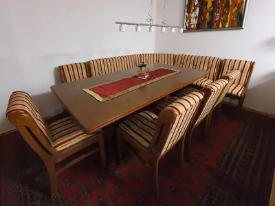a dining room table and chairs with a red napkin at Počitniška hiša Grube z wellnesom in Puconci