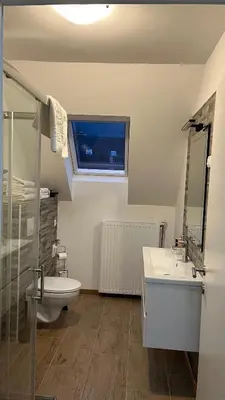 a bathroom with a sink and a toilet and a window at Vila K29 in Bovec