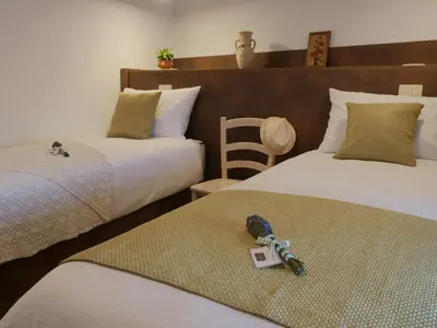 two beds with a toy soldier sitting on top of them at Apartmaji in sobe Odlična hiša Štanjel in Štanjel