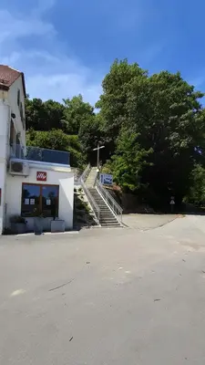 a building with stairs next to a parking lot at Apartma na hüti in Radenci