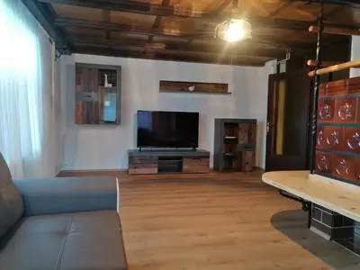 a living room with a couch and a flat screen tv at Apartment V&N, LAKE BOHINJ in Bohinj