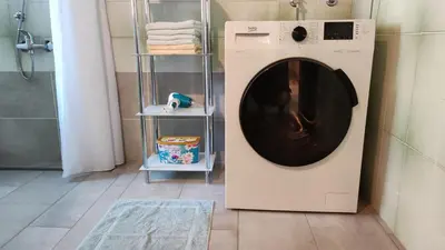 a washing machine in a bathroom next to a shower at Apartment V&N, LAKE BOHINJ in Bohinj