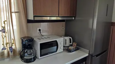 a kitchen counter with a microwave and a refrigerator at Apartment V&N, LAKE BOHINJ in Bohinj