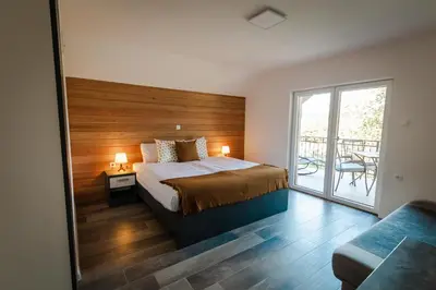a bedroom with a bed and a balcony at Vineyard cottage Radulja in Smarjeske Toplice