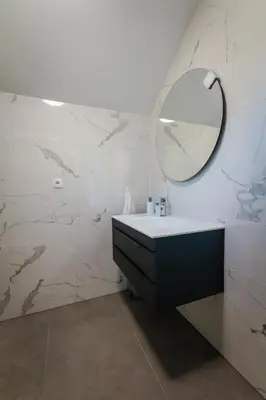 a bathroom with a sink and a mirror on the wall at Vineyard cottage Radulja in Smarjeske Toplice