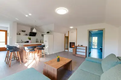 a living room with a couch and a table at Vineyard cottage Radulja in Smarjeske Toplice
