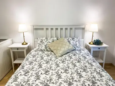 a bedroom with a bed with two night stands at Lakeview Villa Bled in Bled