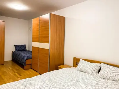 a bedroom with a bed and a closet and a bed at Lakeview Villa Bled in Bled
