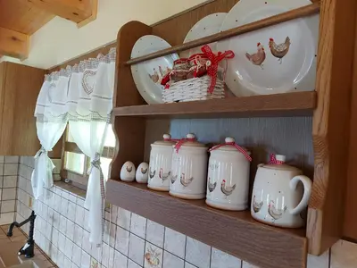 a shelf with plates and cups and dishes on it at Oldhouse Knezovo in Sromlje