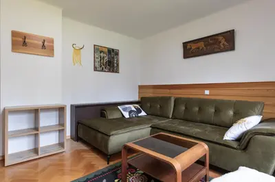 a living room with a couch and a table at Sobe v Gozdu in Gozd Martuljek