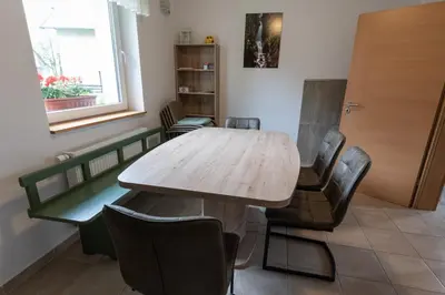 a conference room with a wooden table and chairs at Sobe v Gozdu in Gozd Martuljek