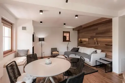 a living room with a table and a couch at Tromeja in Rateče
