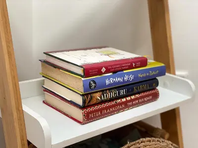 a stack of books sitting on top of a shelf at Cozy Apartment Bovec in Bovec