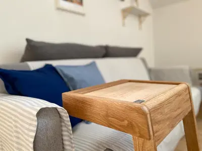 a wooden end table sitting next to a couch at Cozy Apartment Bovec in Bovec