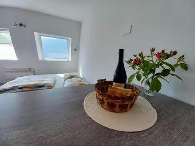 a bottle of wine in a basket on a table at Cozy Apartment Bovec in Bovec