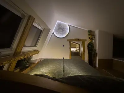 an attic room with a bed and a window at Cozy Apartment Bovec in Bovec