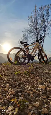 a bike laying on top of a rocky ground at PRENOČIŠČE 9a in Tolmin