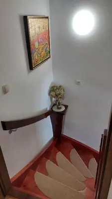 a hallway with a vase of flowers on a wall at Apartma pri Gradu in Brežice