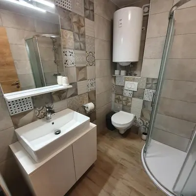 a bathroom with a sink and a shower and a toilet at Apartma Rožle in Mojstrana