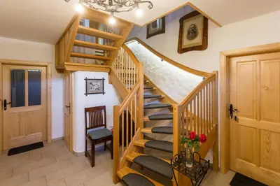a wooden staircase in a room with a stair case at Frida's Old House in Bled