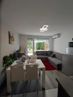 a living room with a white table and chairs at Apartment Mojca in Bovec