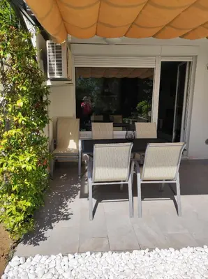 a patio with a table and chairs on a porch at Apartment Mojca in Bovec