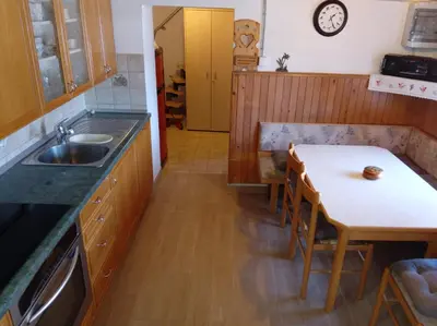 a kitchen with a small table and a sink at Mountain house MINKA in Srednja Vas v Bohinju