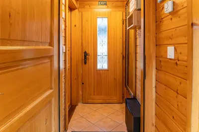 a hallway with a door and a window at Bella Mura Nature Chalet I27 in Podčetrtek