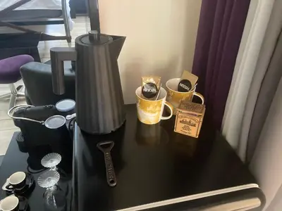 a table with a coffee maker and two cups on it at The Lodge in Rogaška Slatina