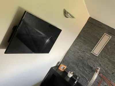 a large flat screen tv hanging on a wall at The Lodge in Rogaška Slatina