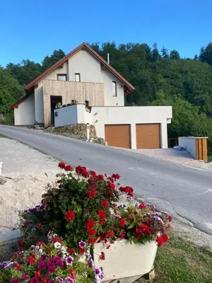 a house with flowers on the side of a road at The Lodge in Rogaška Slatina