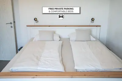 two beds sitting next to each other in a room at Perfect stay in Šentilj